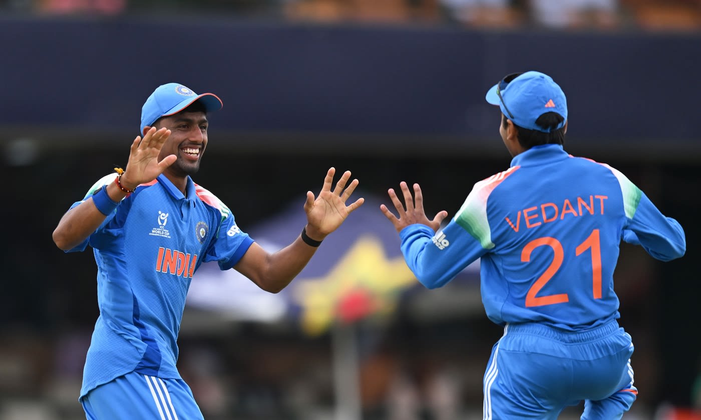 Henil Patel celebrates with Vedant Trivedi after taking a catch