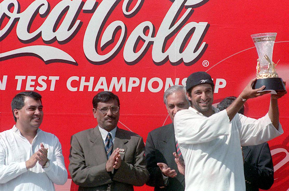 Wasim Akram lifts the Asian Test Championship trophy