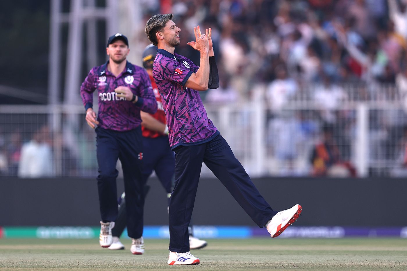 Brad Currie celebrates the wicket of Jos Buttler