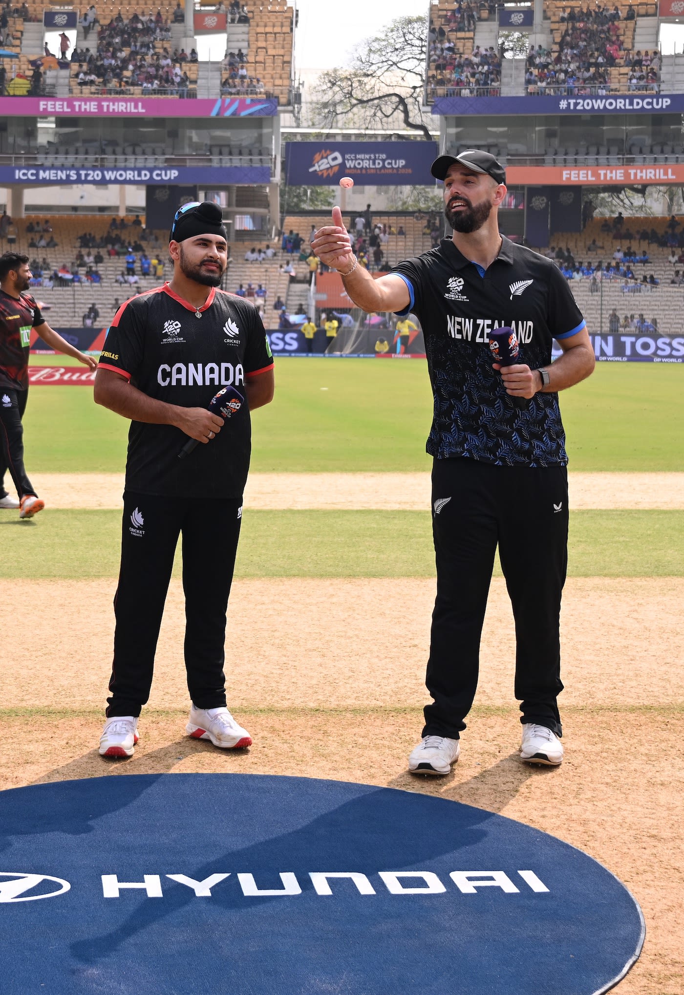 Daryl Mitchell flips the coin as Dilpreet Bajwa calls