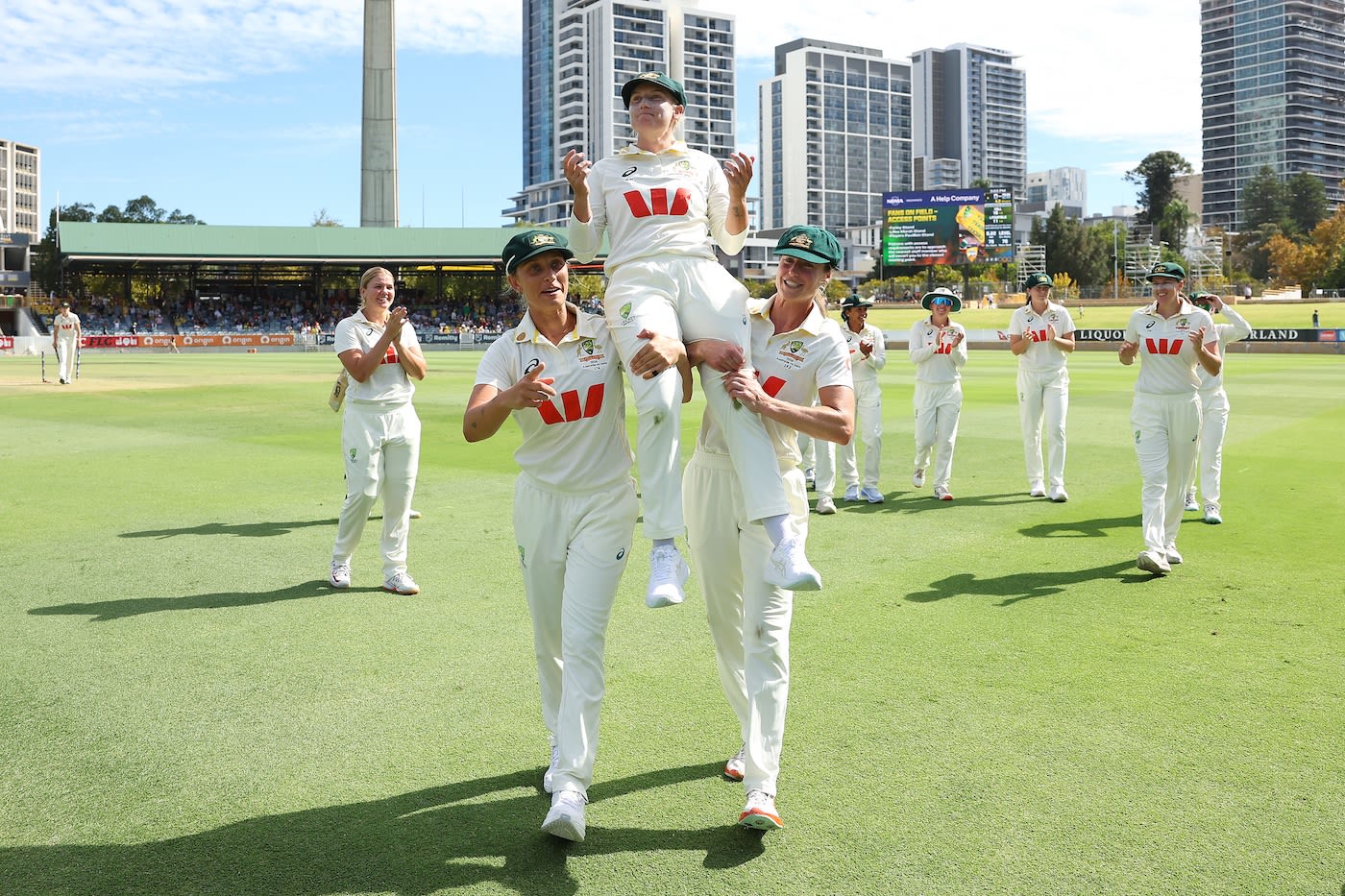 Alyssa Healy is chaired off the ground by Ash Gardner and Ellyse Perry