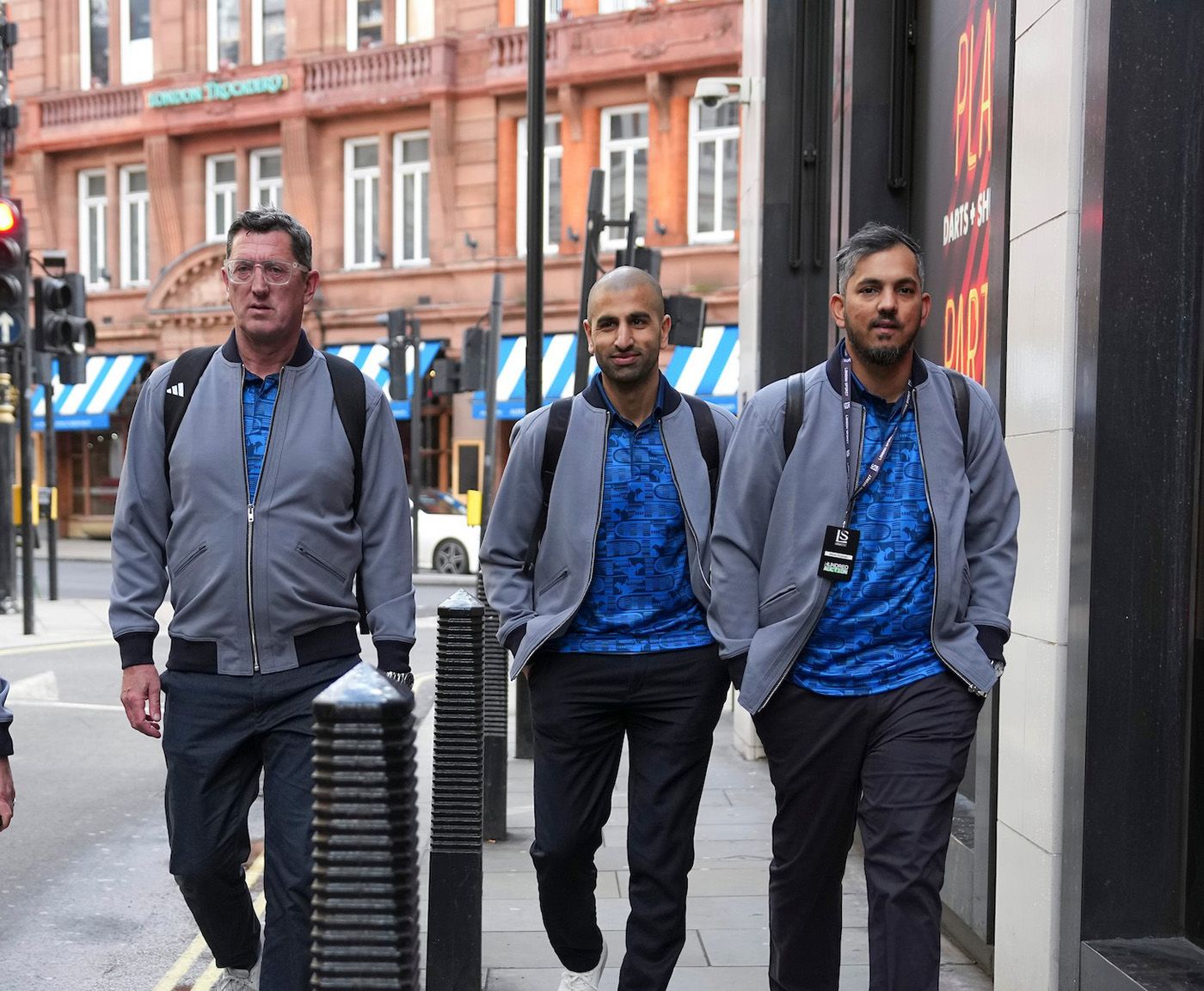 Malolan Rangarajan (R) makes his way into the Women's Hundred auction with (L-R) Jon Lewis and Mo Bobat