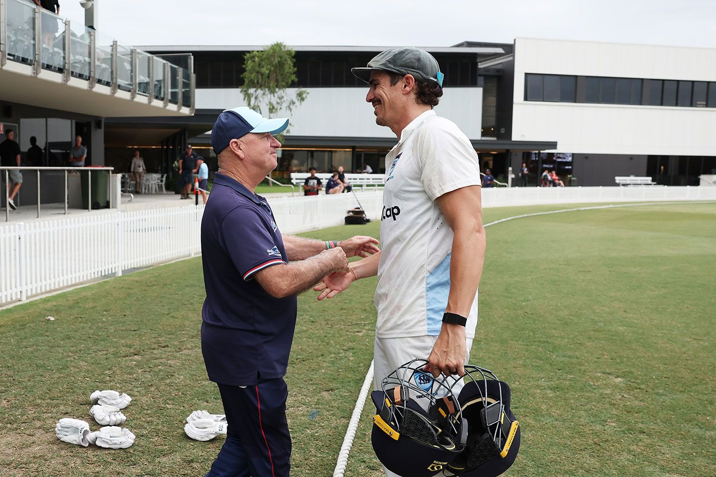 Departing coach Greg Shipperd greets Sean Abbott after the match