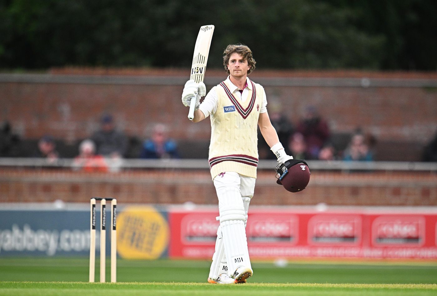 Tom Abell raises his bat on reaching a hundred