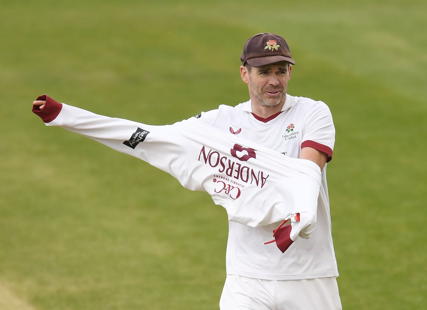 James Anderson pulls on his sweater after a wicket-taking spell