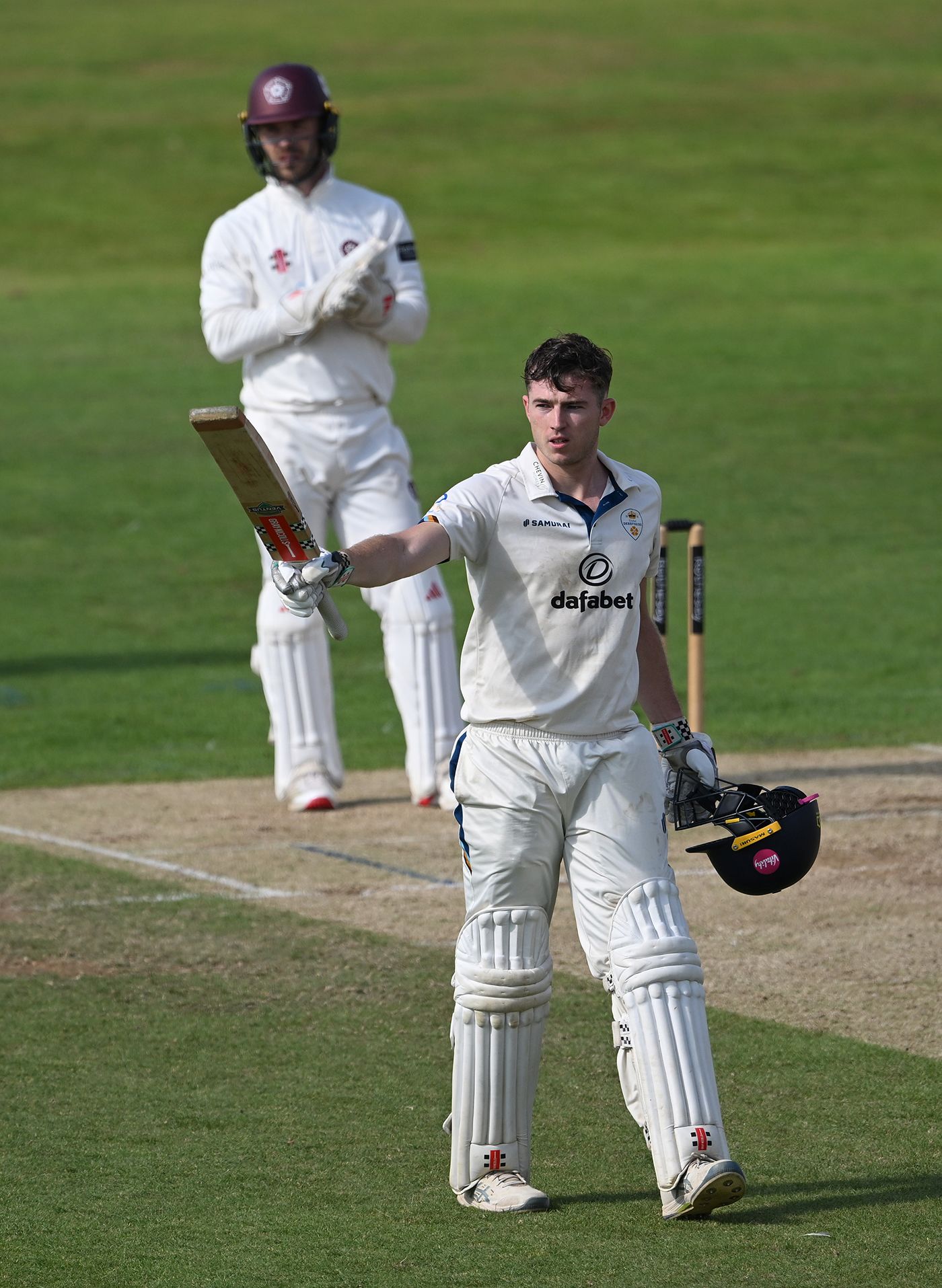 Martin Andersson raises his bat for a century