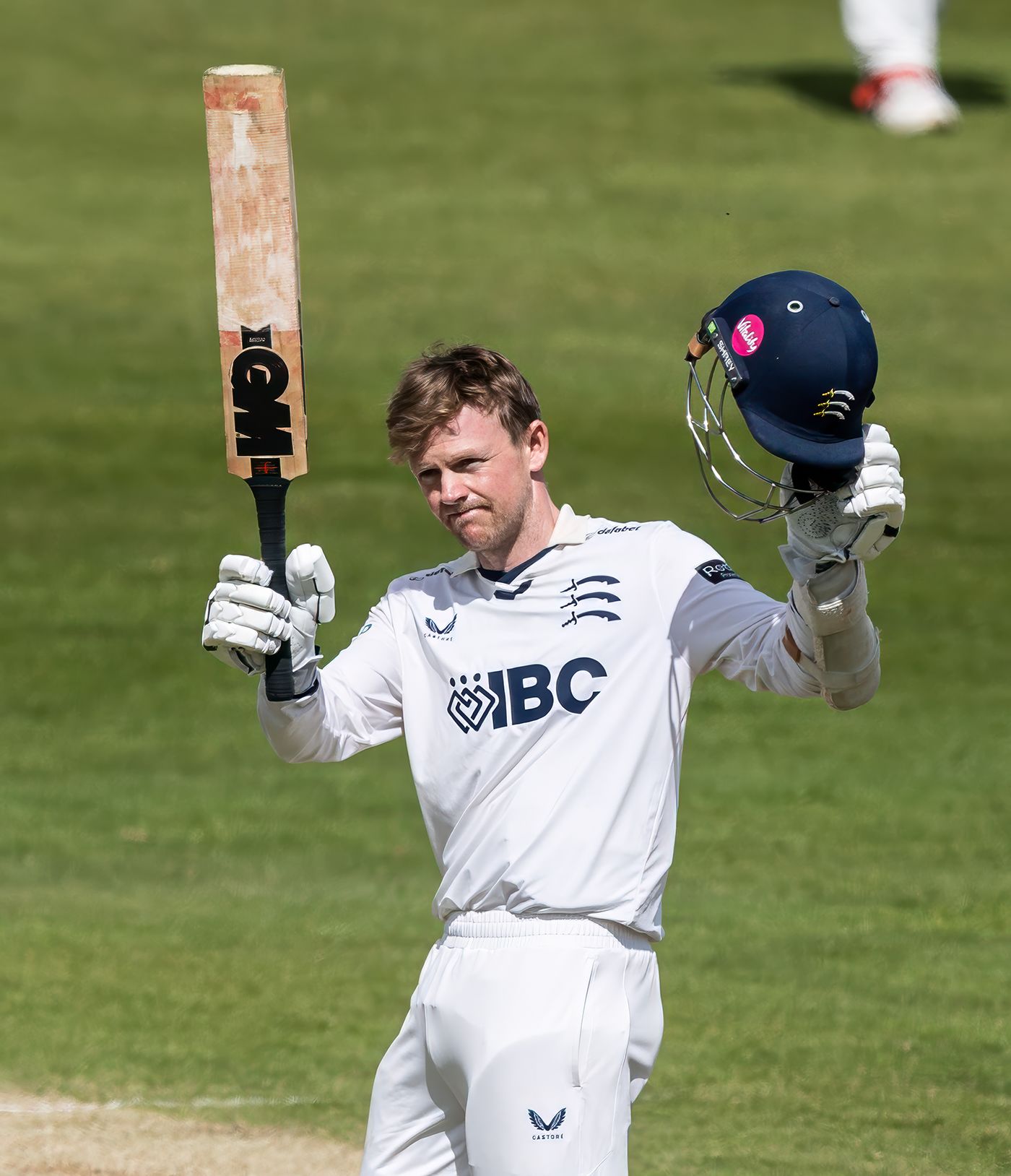 Sam Robson raises his bat on reaching a century