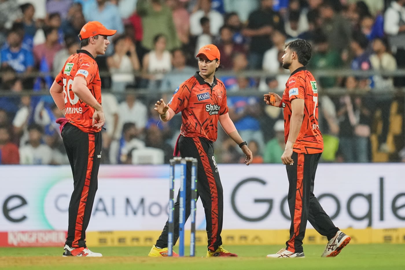 Pat Cummins, Abhishek Sharma and Harsh Dubey strategise