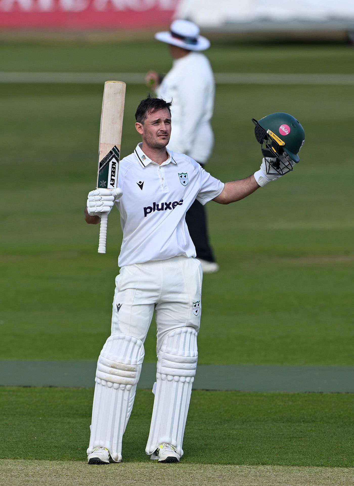 Gareth Roderick raises his bat on reaching a century