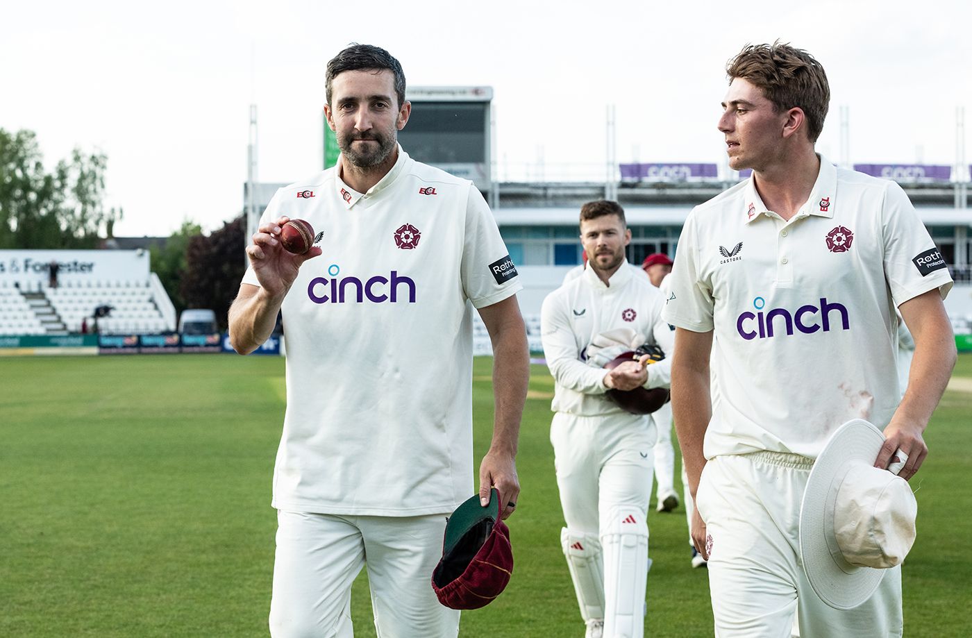 Ben Sanderson holds up the ball after his 11-wicket haul sealed victory