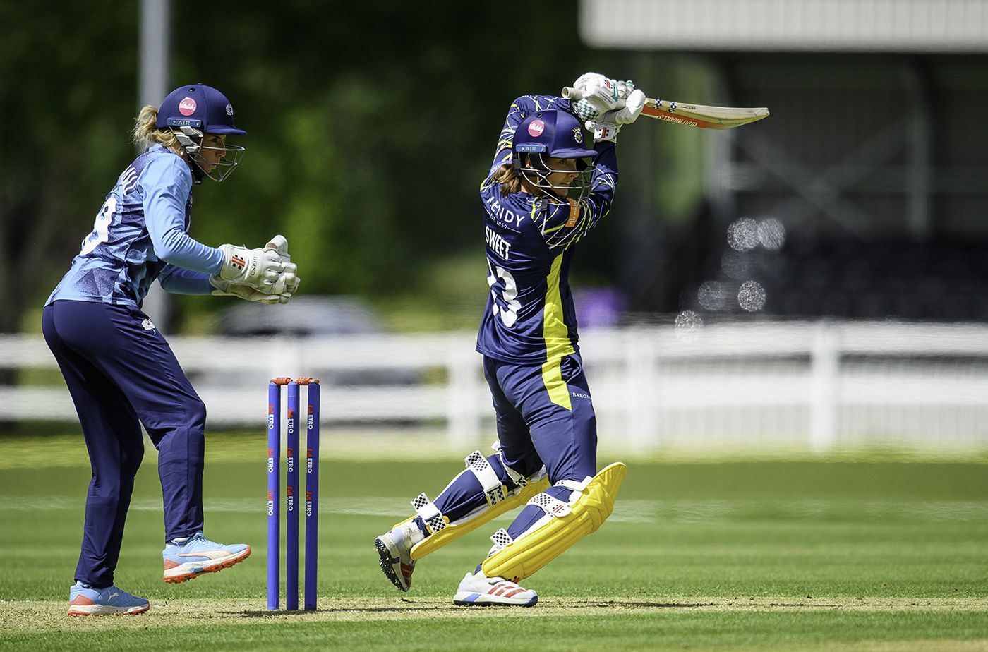 Francesca Sweet punches a drive during her half-century