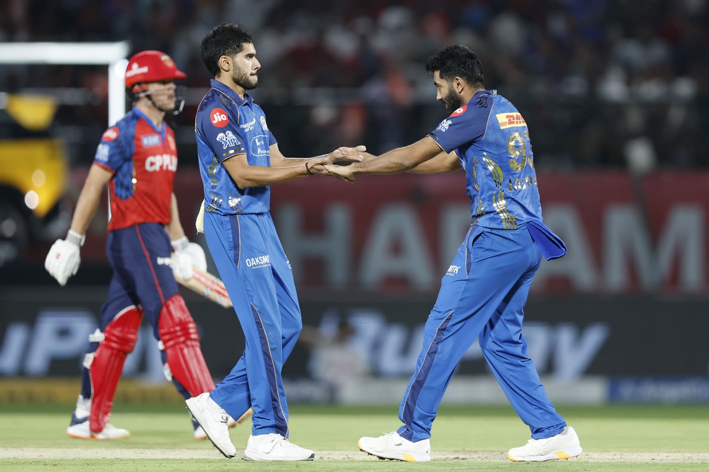 Raj Bawa is congratulated by Jasprit Bumrah on taking a wicket
