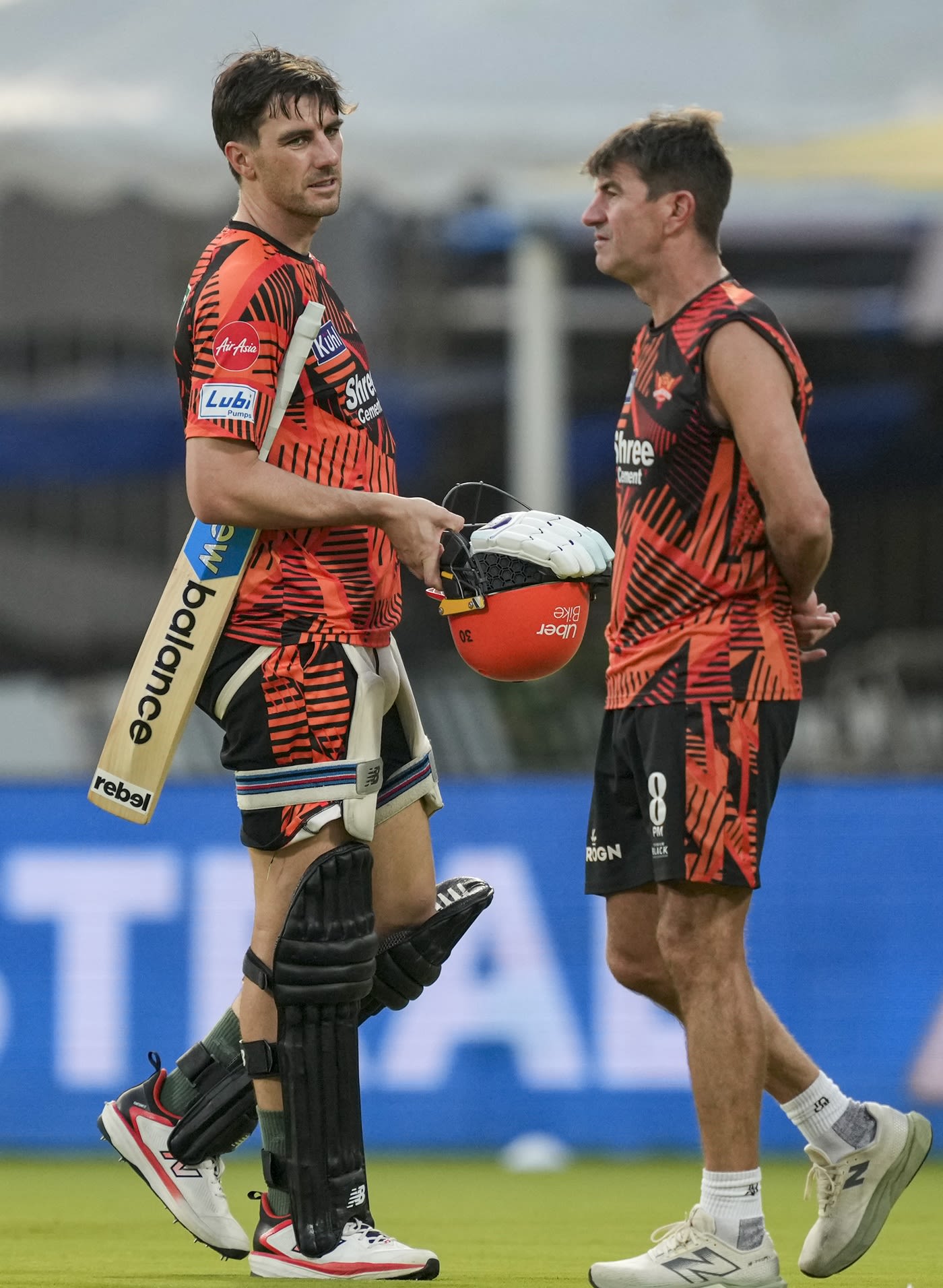 Pat Cummins has a chat with assistant coach Simon Helmot