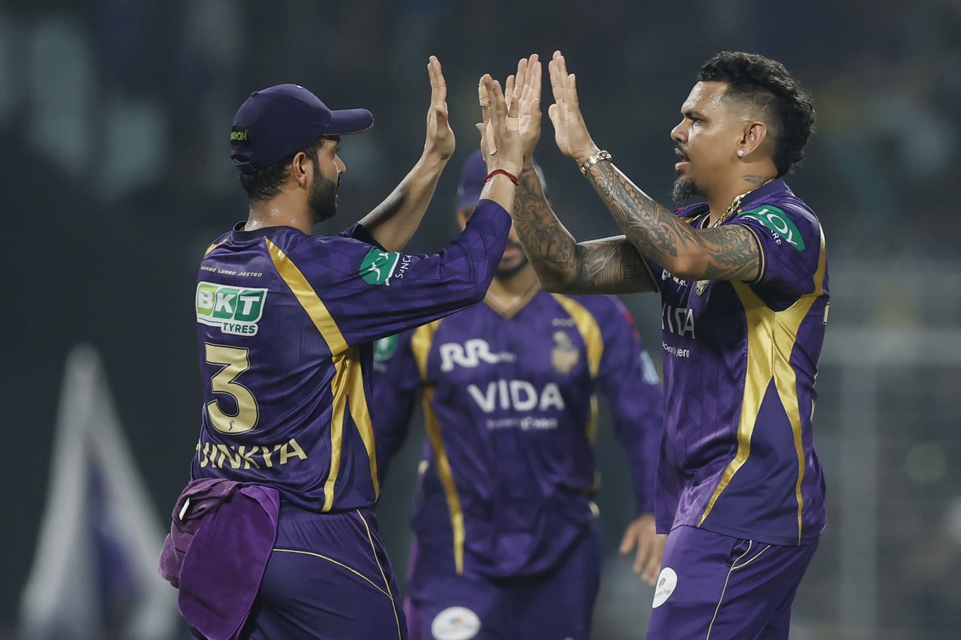 Sunil Narine celebrates a wicket with Ajinkya Rahane
