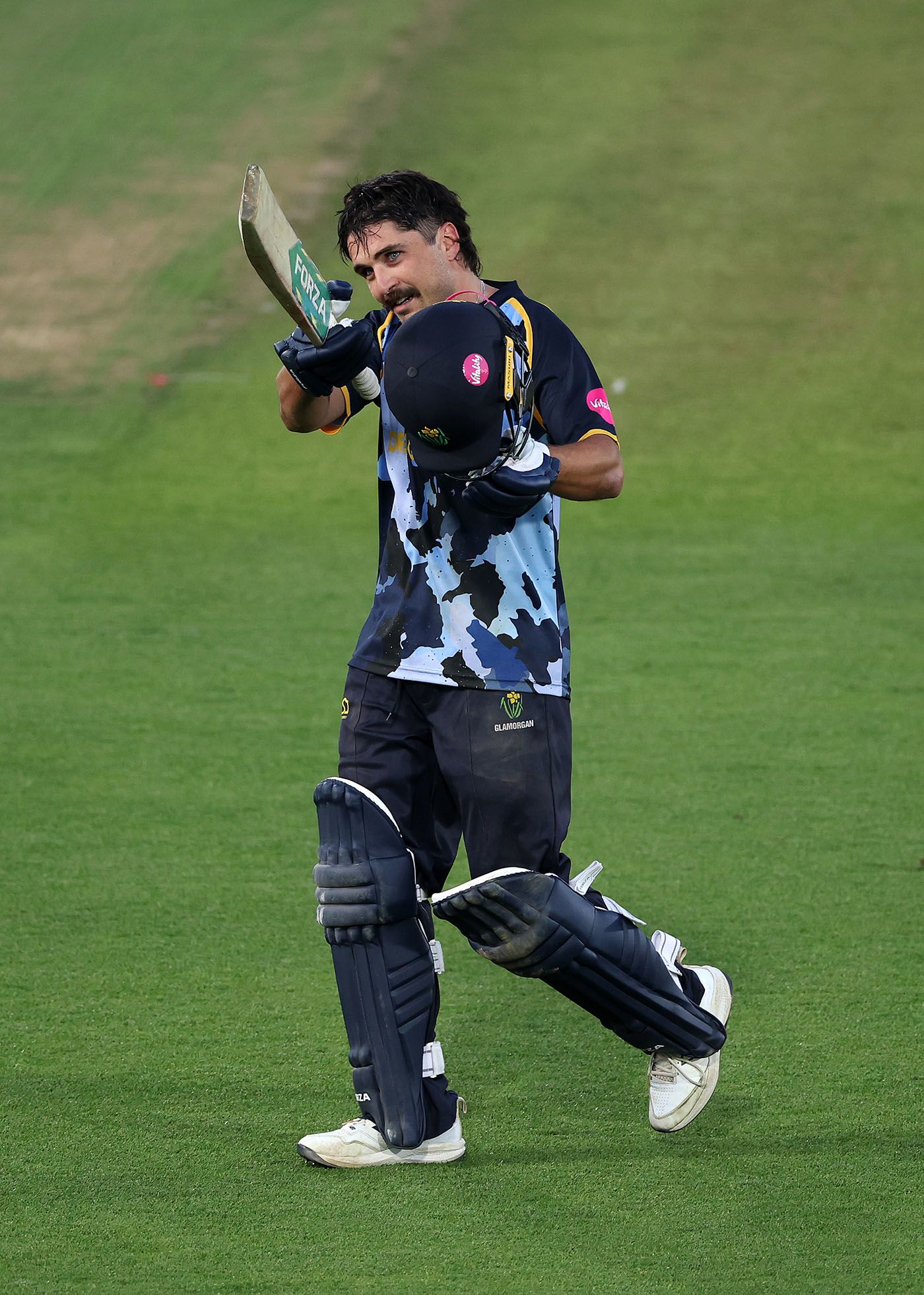 Kiran Carlson acknowledges the crowd as he leaves the field after reaching his century