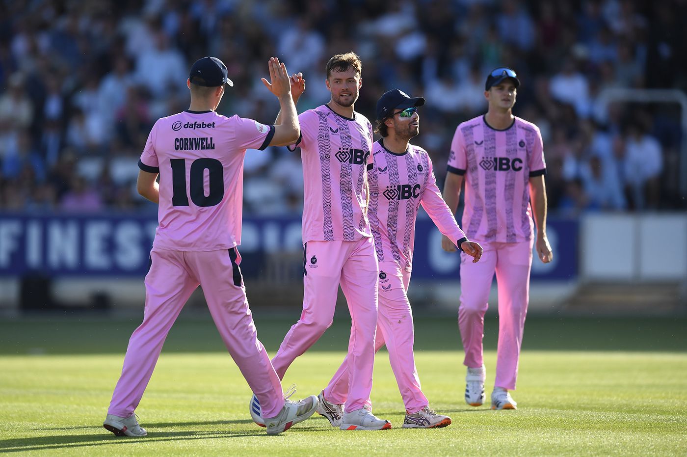 Tom Helm is congratulated by his team-mates