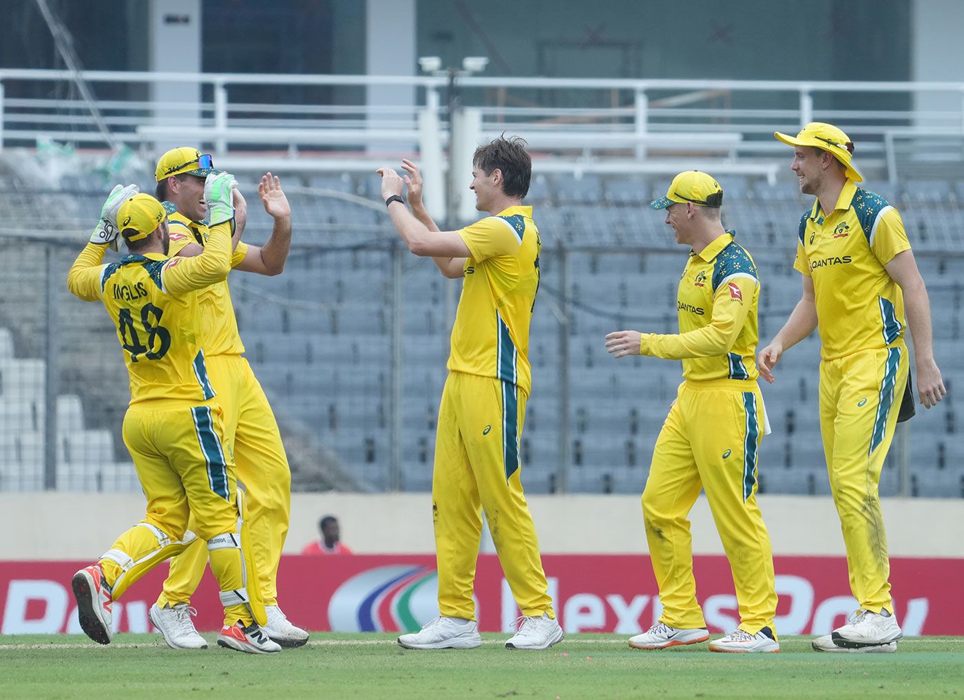 Liam Scott (centre) celebrates his first international wicket