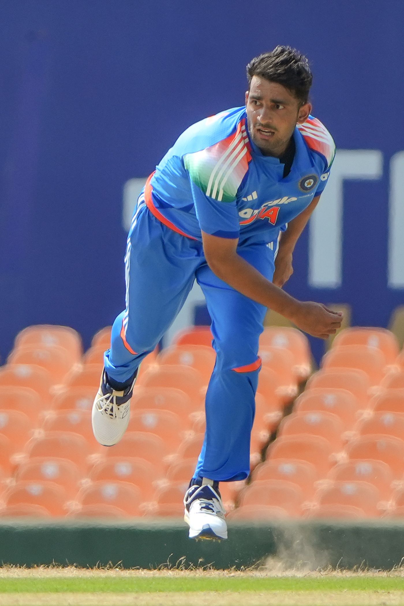 Anshul Kamboj runs in to bowl