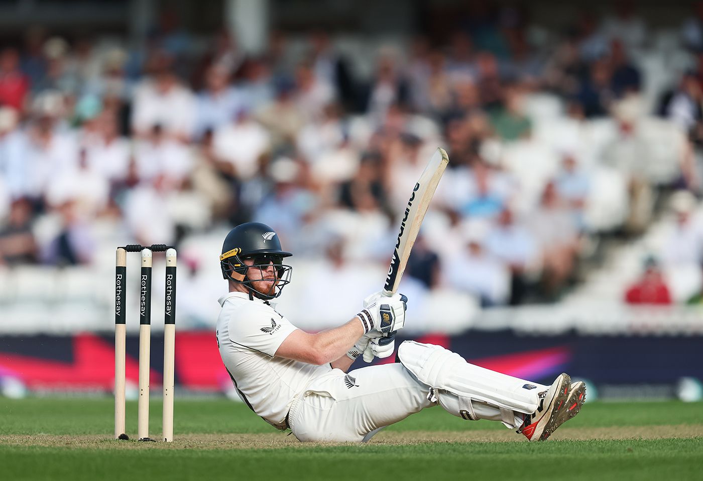 Glenn Phillips, batting in sunglasses, takes evasive action to Jofra Archer's short ball
