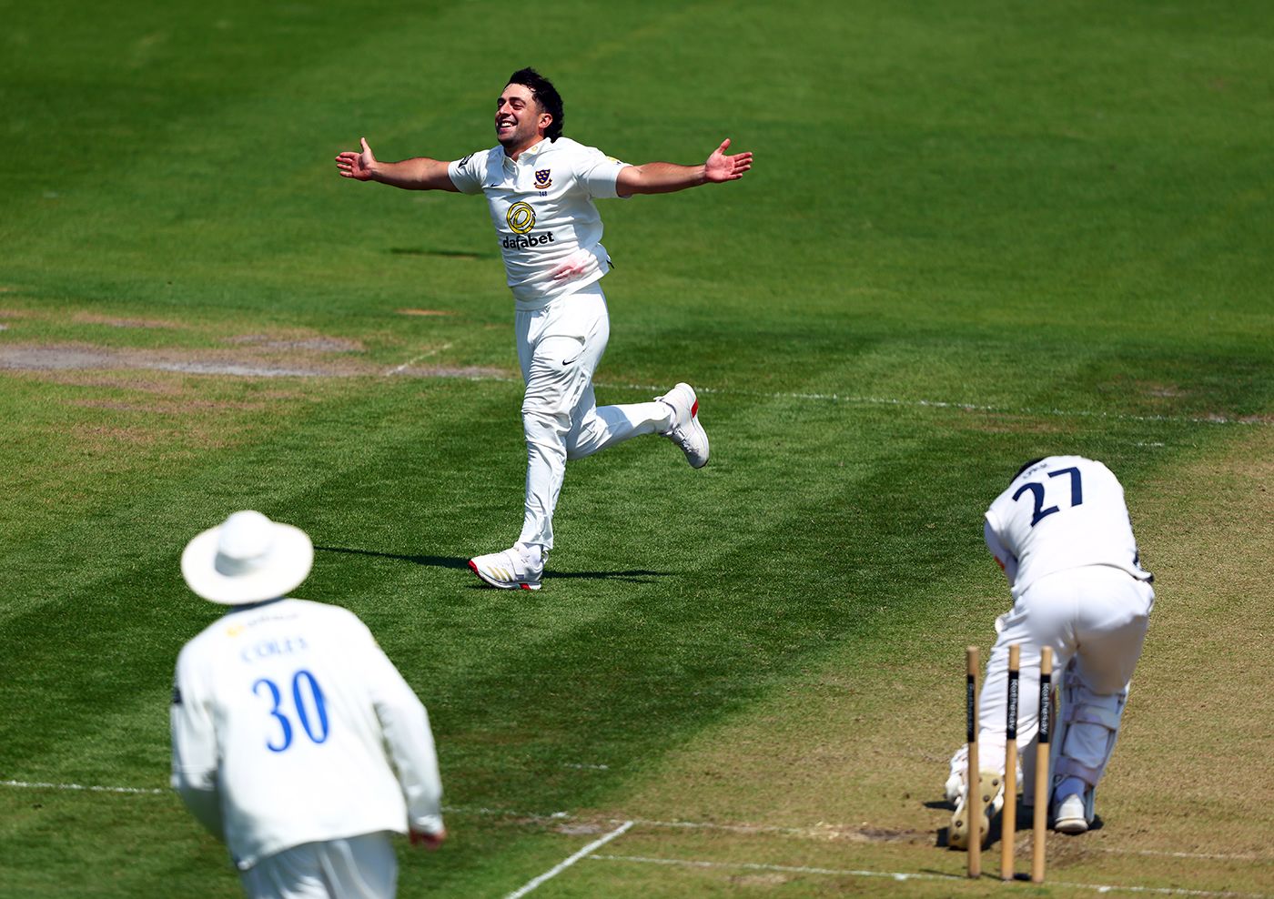 Tom Haines celebrates after bowling Ali Orr