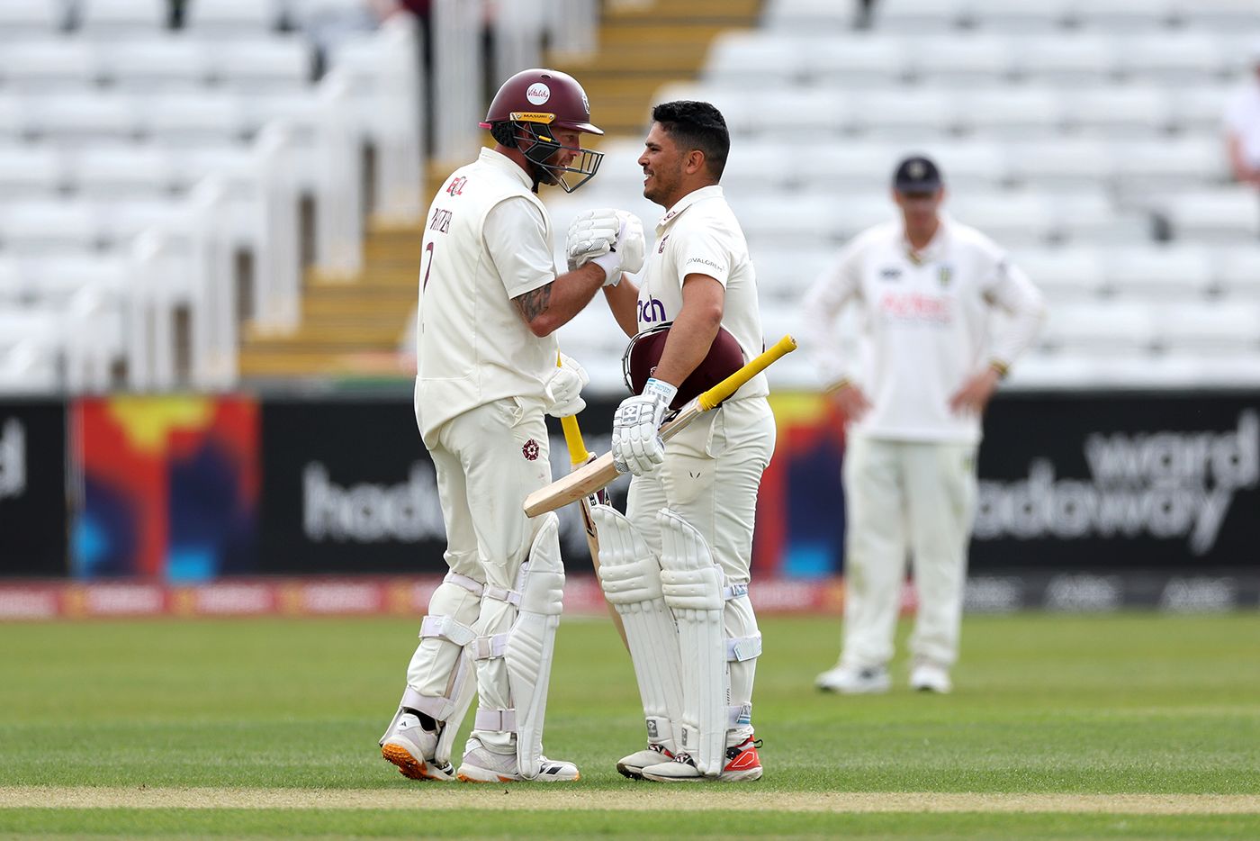 Luke Procter congratulates Ricardo Vasconcelos on his hundred