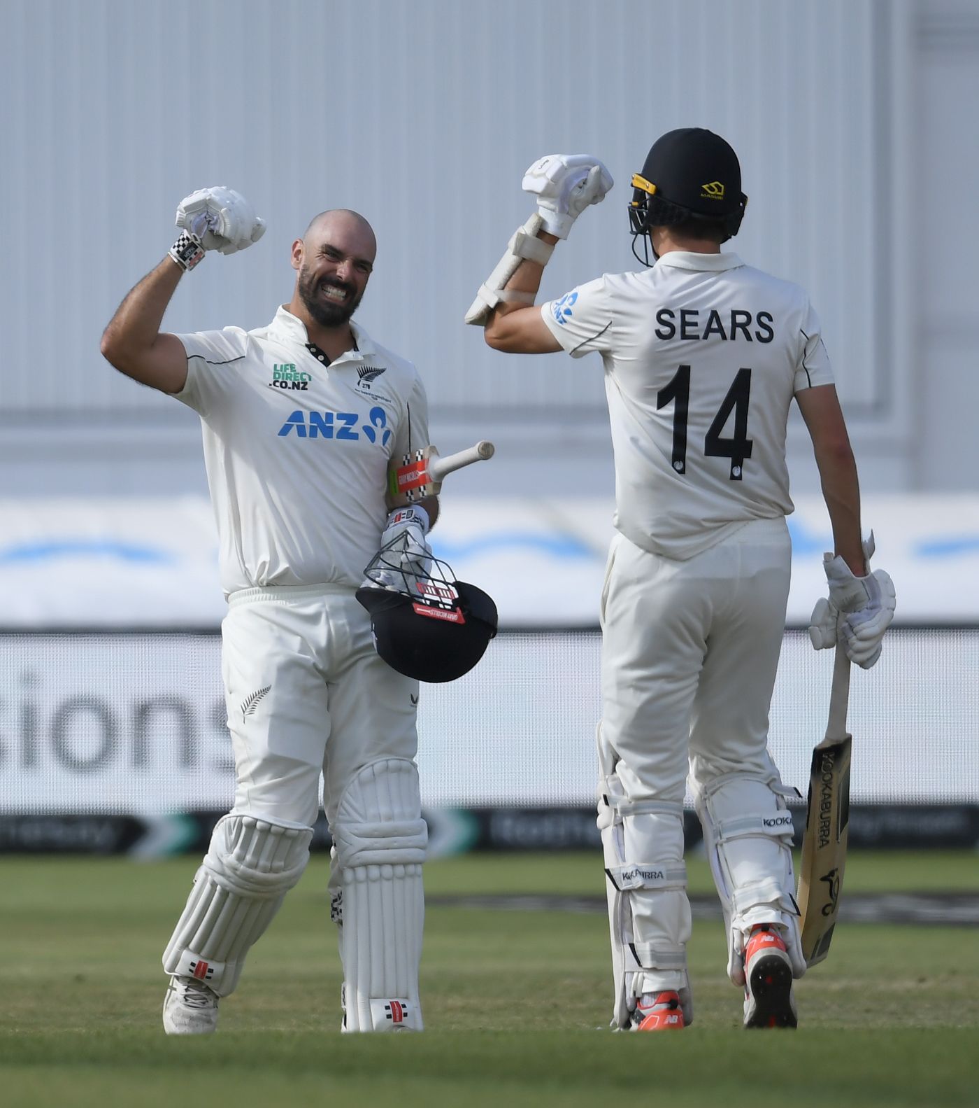 Daryl Mitchell celebrates with Ben Sears after his gutsy century