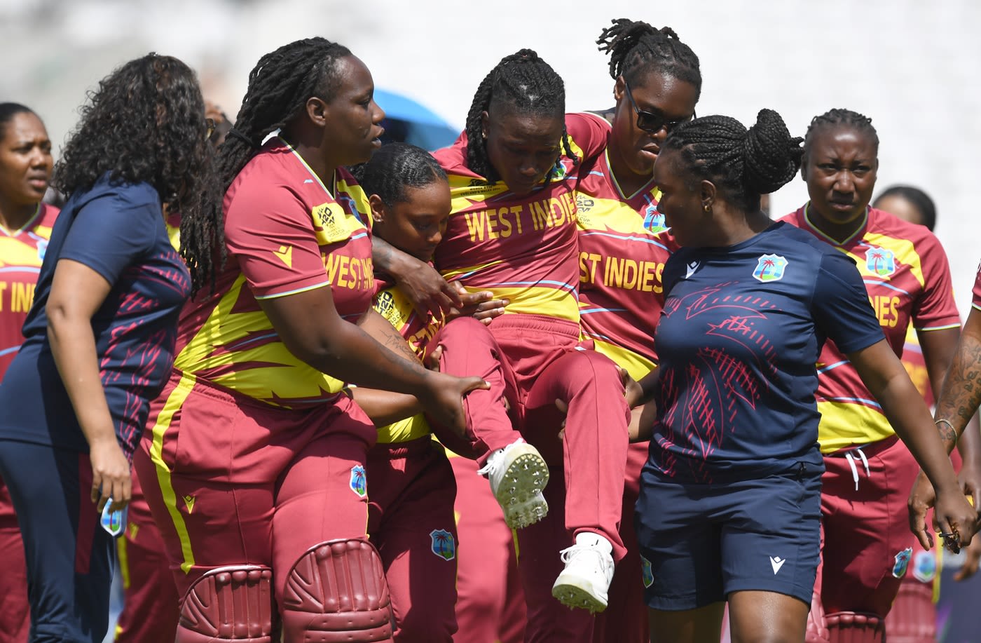 Deandra Dottin's team-mates carry her off the field after the anthems