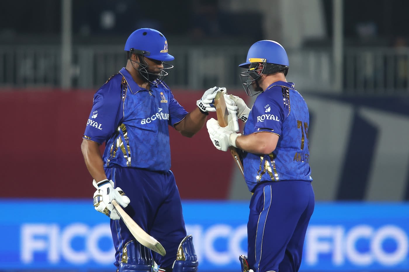 Kieron Pollard is congratulated by Corey Anderson after his fifty