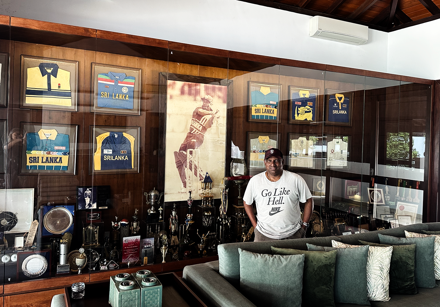 Aravinda de Silva poses at home with the memorabilia and trophies he's collected over his career