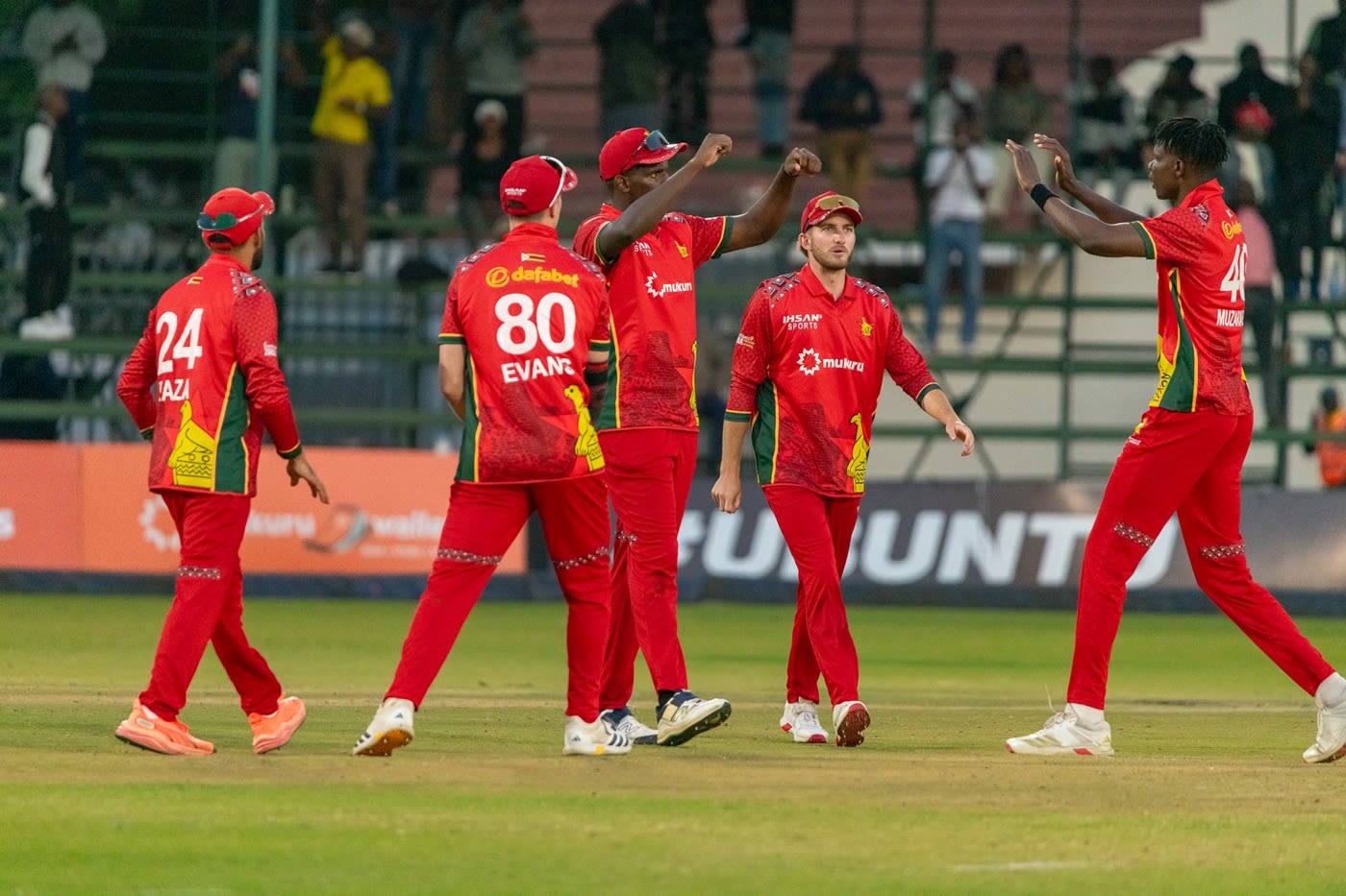 Blessing Muzarabani celebrates a wicket with his team-mates