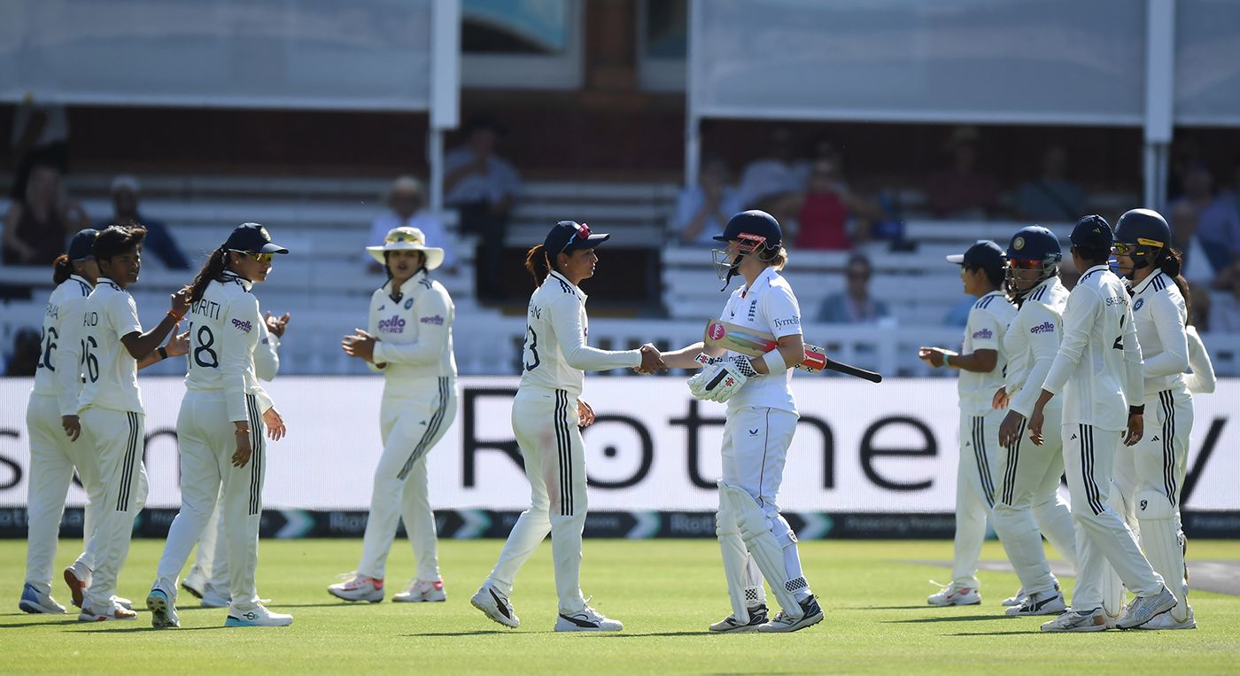 The retiring Heather Knight gets a handshake from Harmanpreet Kaur