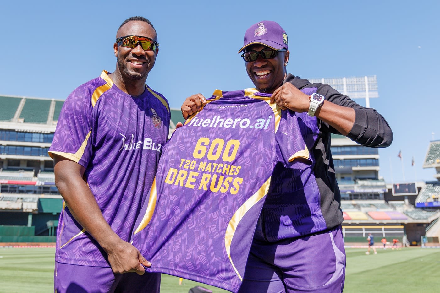 Dwayne Bravo presents Andre Russell a special jersey after the latter became just the third man to play 600 T20s
