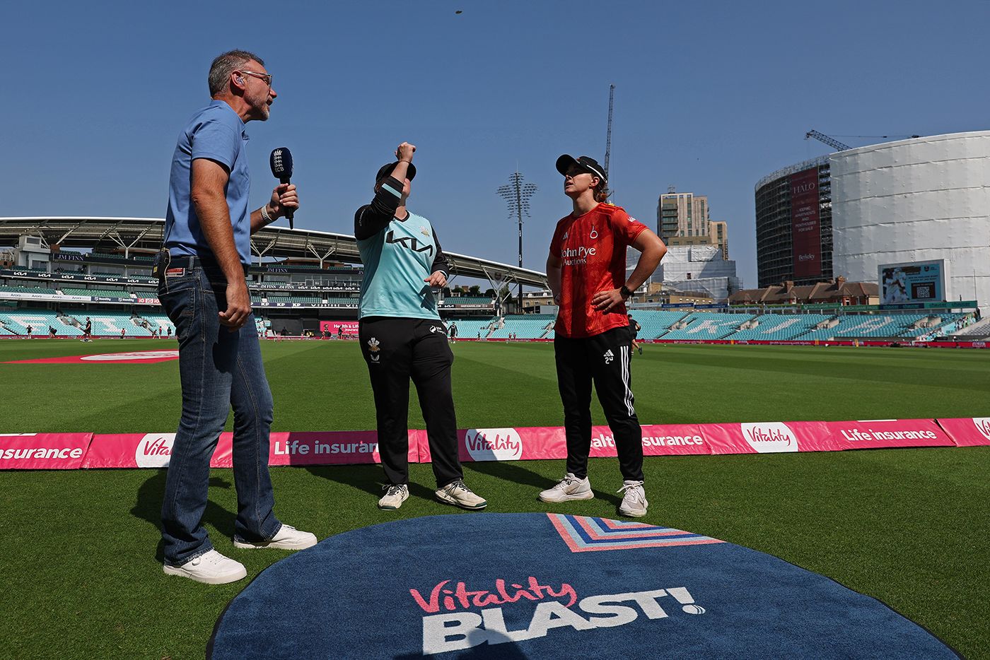 Bryony Smith tosses the coin as Kirstie Gordon looks on