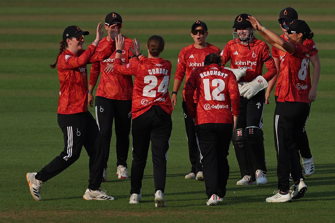 Lucy Higham and Kirstie Gordon celebrate taking the wicket of Mady Villiers