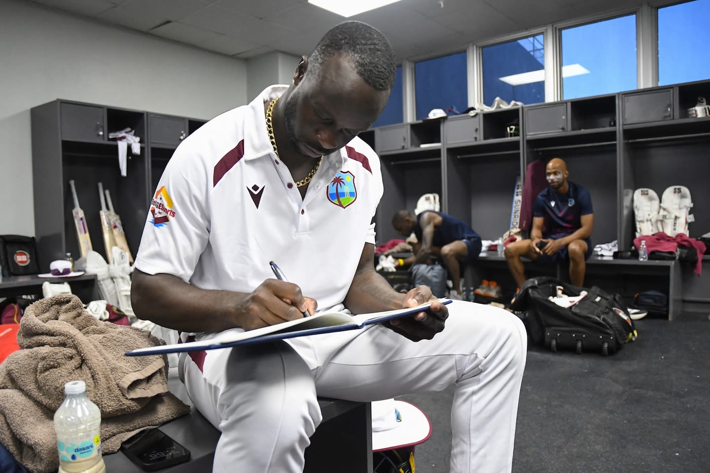 Kemar Roach signs the condolence book for the late Sir Garry Sobers
