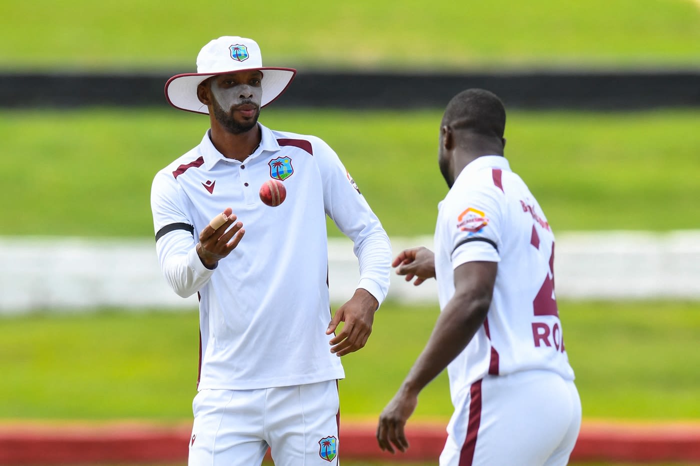 Roston Chase throws the ball to Kemar Roach