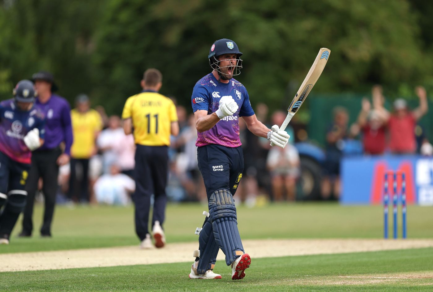 Will Rhodes celebrates the winning runs after his unbeaten hundred