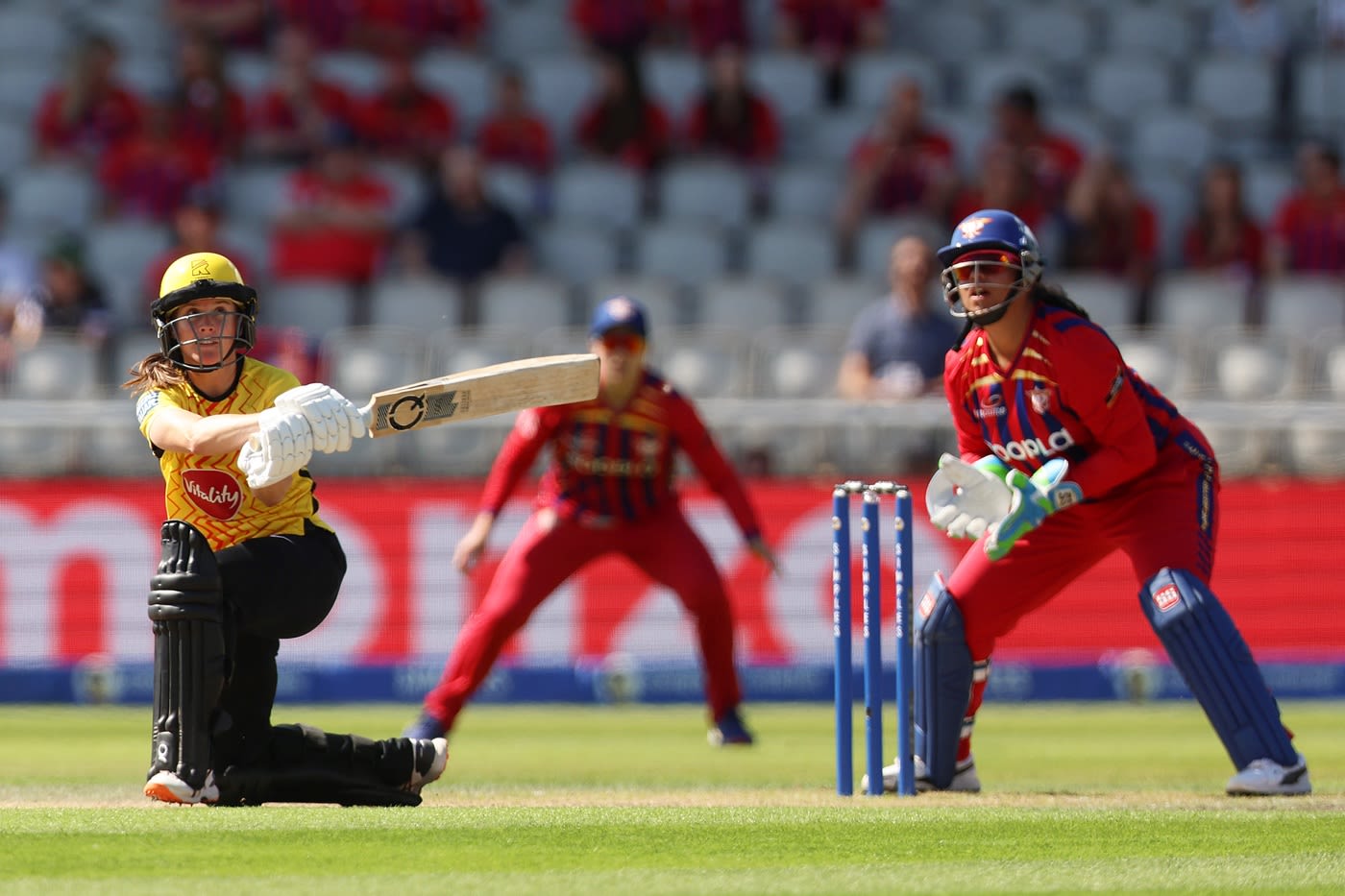 Sophie Luff puts one away as Richa Ghosh looks on