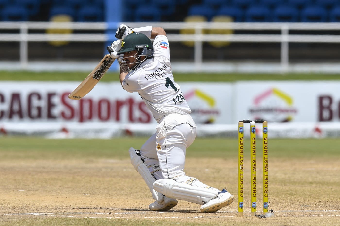 Azan Awais punches with a high elbow