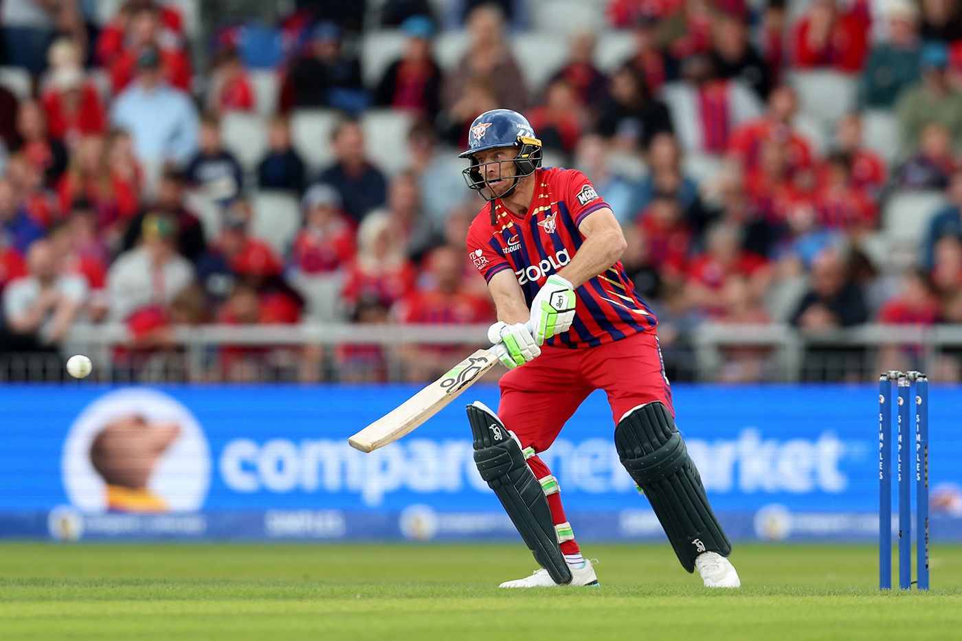 Jos Buttler scoops during his 20-ball fifty