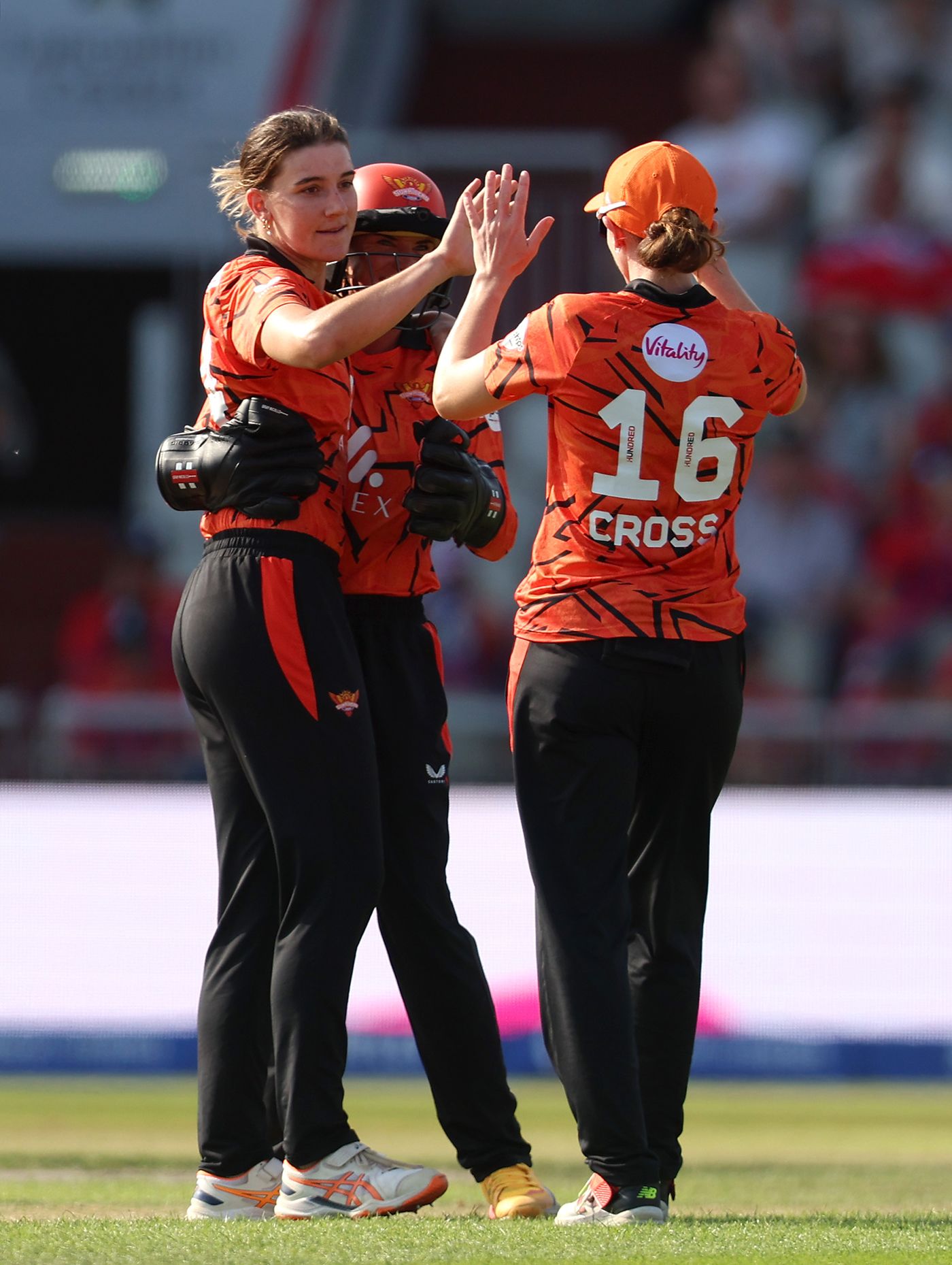 Annabel Sutherland celebrates with Kate Cross and Lauren Winfield-Hill