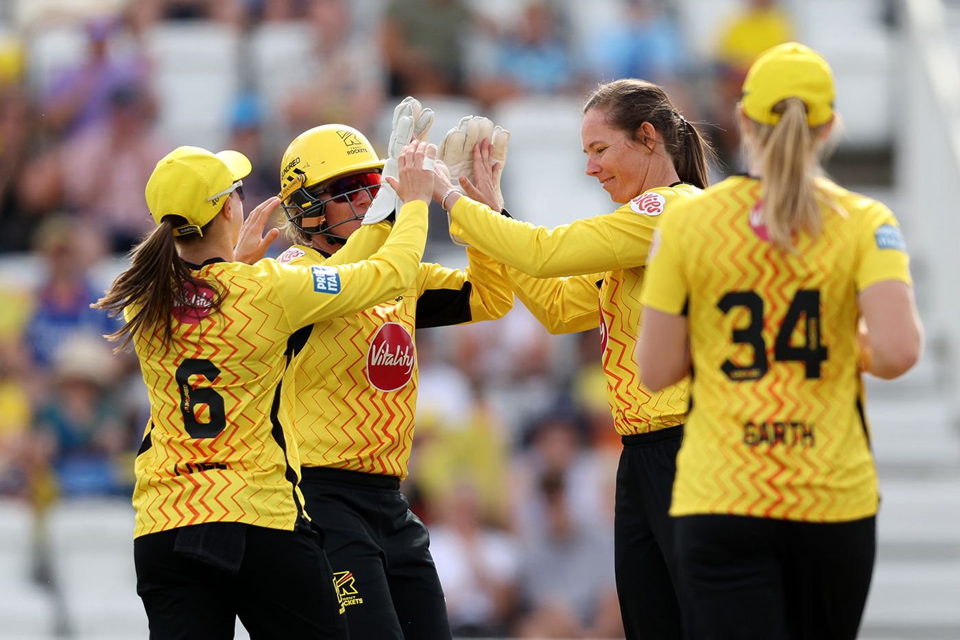 Sam Bates celebrates a wicket with Beth Mooney