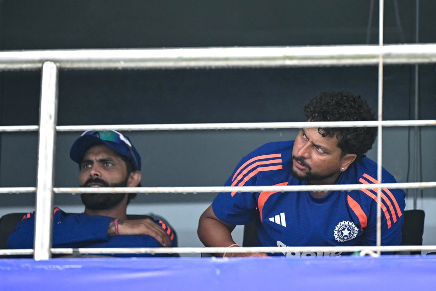 Ravindra Jadeja and Kuldeep Yadav wait for the rain to relent
