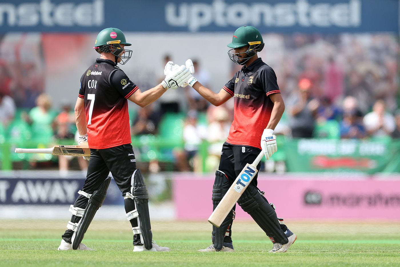 Hamza Shaikh celebrates his century with Ben Cox