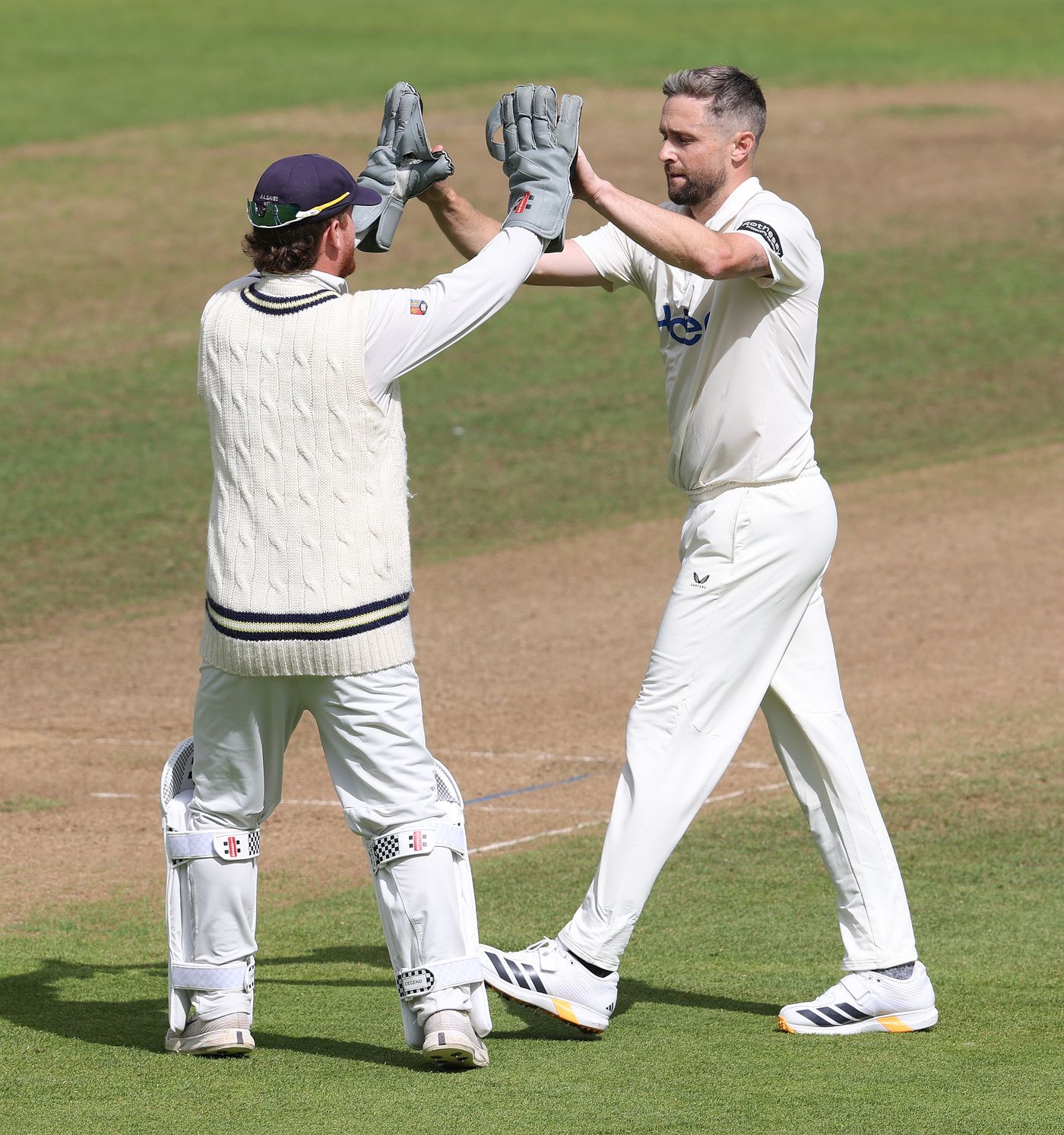 Chris Woakes celebrates with Alex Davies