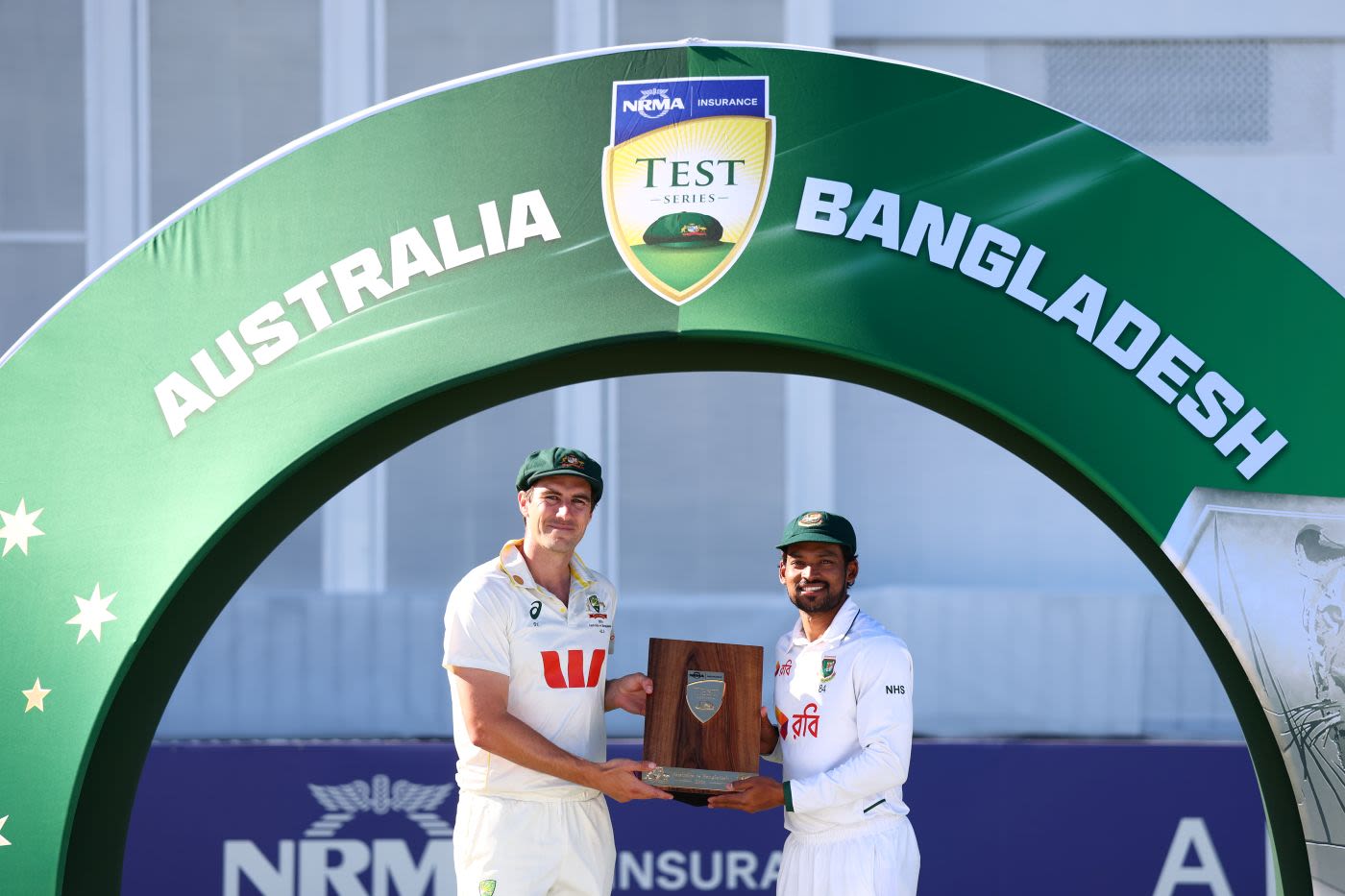 Pat Cummins and Najmul Hossain Shanto pose with the trophy after 1-1 series draw