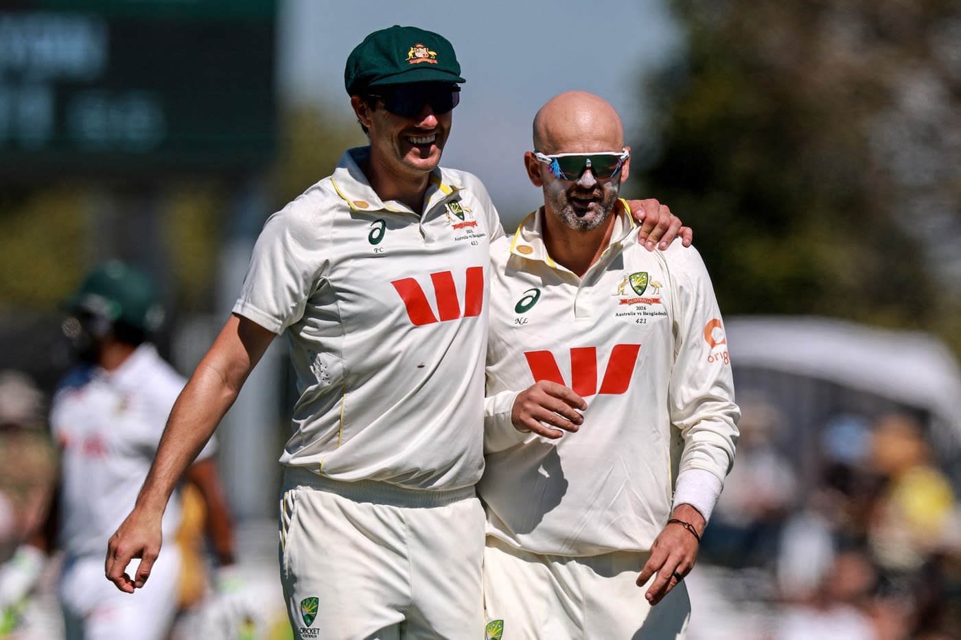 Pat Cummins and Nathan Lyon celebrate a wicket