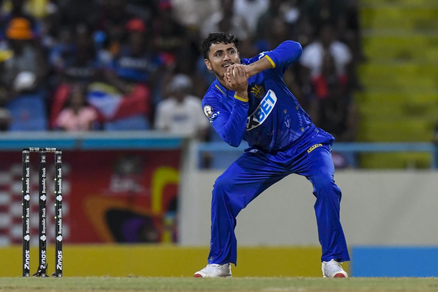 Mujeeb Ur Rahman looks pleased after taking a return catch
