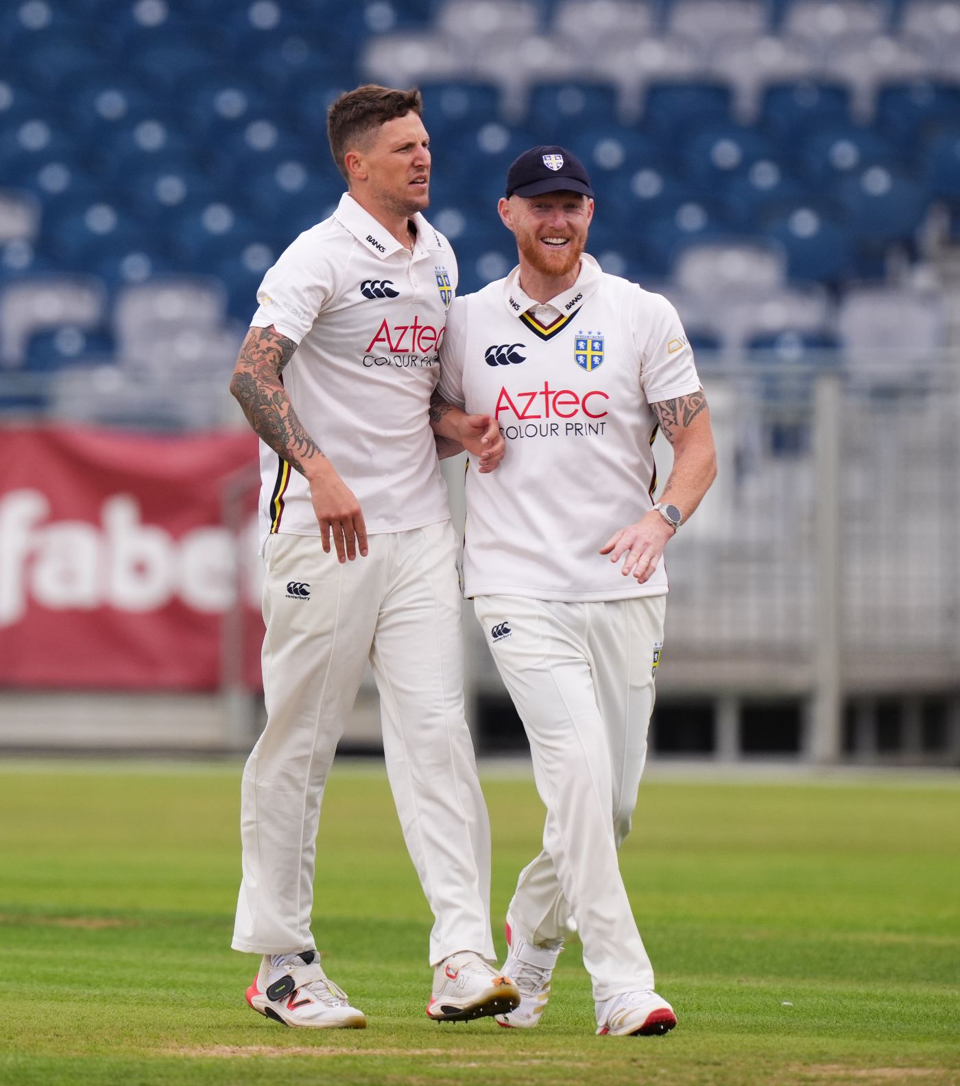 Brydon Carse and Ben Stokes celebrate an early wicket for Durham