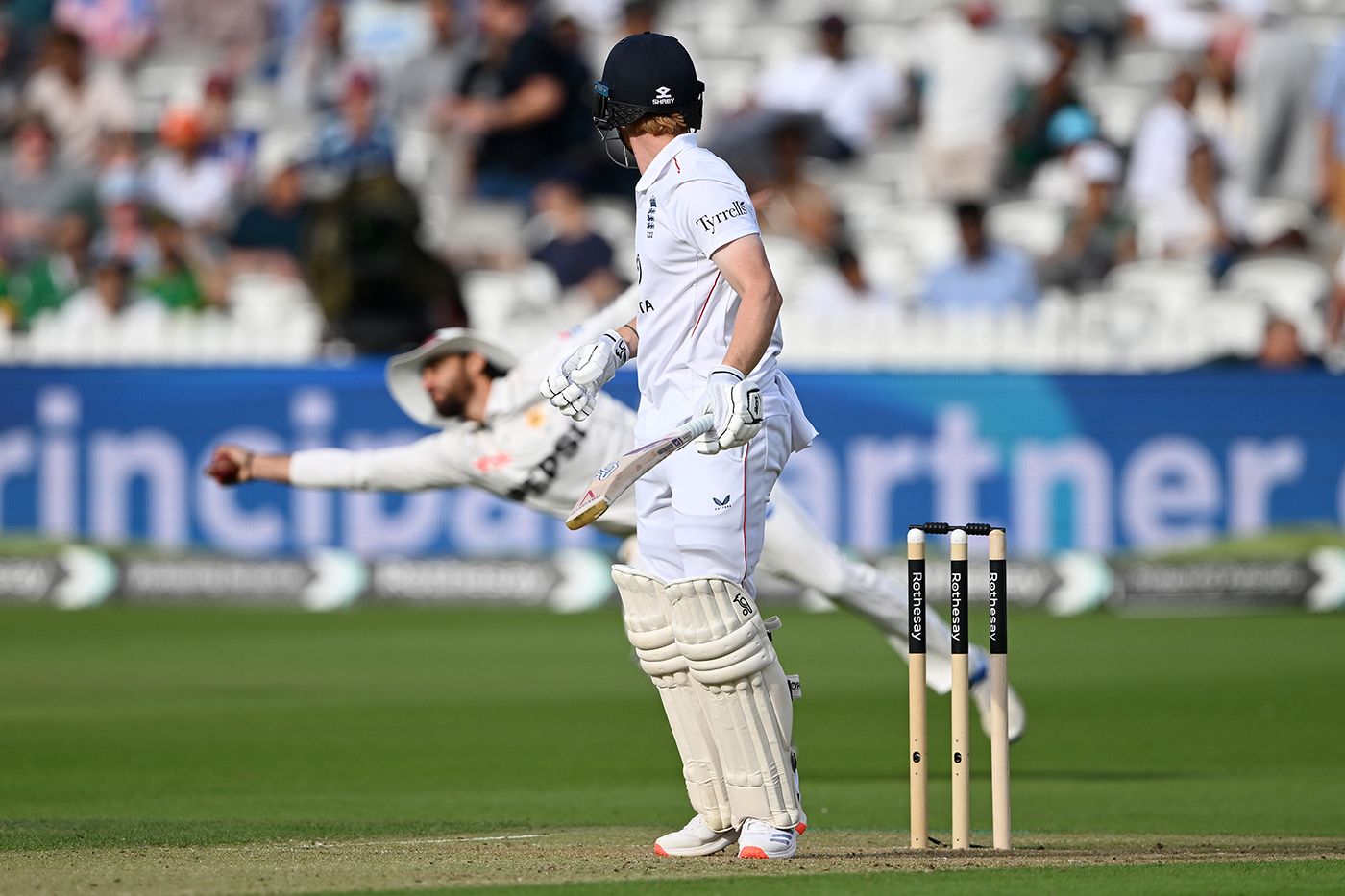 Jordan Cox looks on as Salman Agha leaps to take a one-handed catch